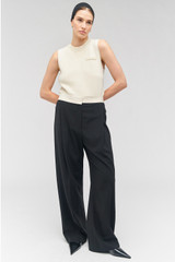 Profile view of model wearing the Oroton Contrast Waist Pant in Black and 53% poly, 42% wool, 5% elastane for Women