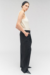 Profile view of model wearing the Oroton Contrast Waist Pant in Black and 53% poly, 42% wool, 5% elastane for Women