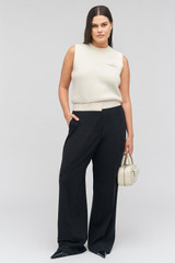 Profile view of model wearing the Oroton Contrast Waist Pant in Black and 53% poly, 42% wool, 5% elastane for Women