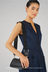 Profile view of model wearing the Oroton Harvey Baguette Crossbody in Black and Smooth leather for Women .
