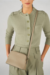 Profile view of model wearing the Oroton Iris Double Zip Crossbody in Mushroom and Premium pebble leather  for Women .