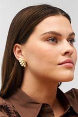 Profile view of model wearing the Oroton Pietra Earrings in 18K Worn Gold/Clotted Cream and Brass for Women