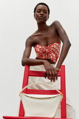 Profile view of model wearing the Oroton Apple Stamp Tie Top in Poppy and 100% cotton for Women .