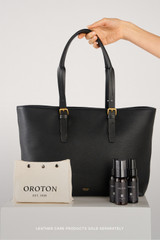 Profile view of model wearing the Oroton Dylan Large Tote in Black and Main body crafted from 100% pebble leather for Women .