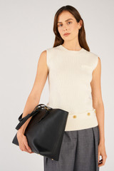 Profile view of model wearing the Oroton Dylan Large Tote in Black and Main body crafted from 100% pebble leather for Women .