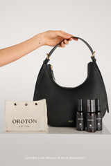 Profile view of model wearing the Oroton Dylan Hobo in Black and Premium pebble leather for Women .