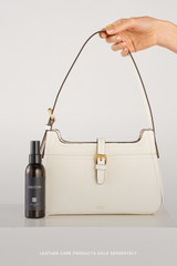 Profile view of model wearing the Oroton Dylan Baguette in Cream and Premium embossed leather for Women .