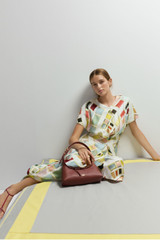 Profile view of model wearing the Oroton Vintage Ribbon Print Dress in Multi and 100% silk fabric for Women .
