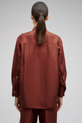 Profile view of model wearing the Oroton Ls Silk Shirt in Barn Red and 100% Silk for Women