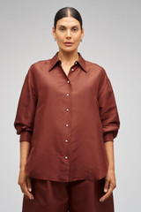 Profile view of model wearing the Oroton Ls Silk Shirt in Barn Red and 100% Silk for Women