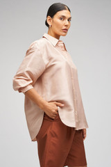 Profile view of model wearing the Oroton Ls Silk Shirt in Pale Rosewood and 100% Silk for Women