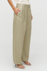 Profile view of model wearing the Oroton Pleat Pant in Laurel and 58% Viscose 42% Linen for Women .