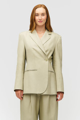 Profile view of model wearing the Oroton Wrap Blazer in Laurel and 58% Viscose 42% Linen for Women .