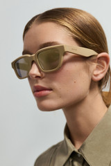 Profile view of model wearing the Oroton Pandora Sunglasses in Wheat and Acetate material for Women .