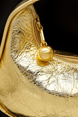 Profile view of model wearing the Oroton Clara Mini Bag in Gold and Metallic crinkle leather for Women .