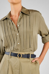 Profile view of model wearing the Oroton Ali Reversible Belt in Brass-Navy/Mushroom and Premium smooth leather for Women .