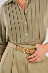 Profile view of model wearing the Oroton Ali Reversible Belt in Brass-Navy/Mushroom and Premium smooth leather for Women .