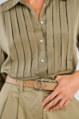 Profile view of model wearing the Oroton Ali Reversible Belt in Silver-Navy/Mushroom and Premium smooth leather for Women .