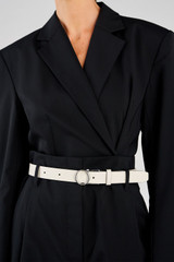 Profile view of model wearing the Oroton Ali Reversible Belt in Silver-Tan/Cream and Premium smooth leather for Women .