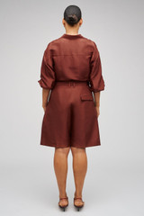 Profile view of model wearing the Oroton Tailored Short in Barn Red and 100% Silk for Women