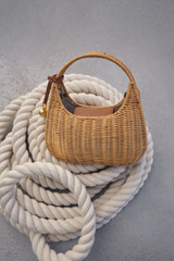 Detail product shot of the Oroton Clara Wicker Mini Bag in Natural/Cognac and Woven wicker exterior for Women .