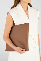 Profile view of model wearing the Oroton Dylan 15" Laptop Pouch in Tan and  for Women .