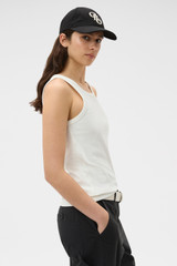 Profile view of model wearing the Oroton Lottie Rib Tank in Antique White and 92% Cotton / 8% Spandex for Women .