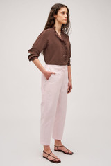 Profile view of model wearing the Oroton Arlo Carpenter Chino in Palest Pink and 100% Cotton for Women