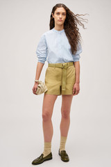 Profile view of model wearing the Oroton Alfie Carpenter Short in Wheat and Crafted from cotton twill  for Women .