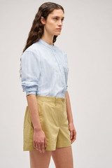 Profile view of model wearing the Oroton Alfie Carpenter Short in Wheat and Crafted from cotton twill  for Women .