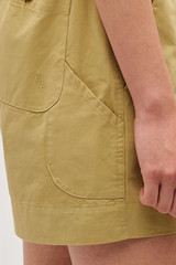 Profile view of model wearing the Oroton Alfie Carpenter Short in Wheat and Crafted from cotton twill  for Women .