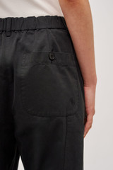 Profile view of model wearing the Oroton Arlo Carpenter Chino in Washed Black and 100% Cotton for Women