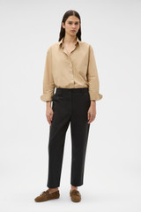 Profile view of model wearing the Oroton Arlo Carpenter Chino in Washed Black and 100% cotton fabric for Women .