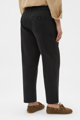 Profile view of model wearing the Oroton Arlo Carpenter Chino in Washed Black and 100% cotton fabric for Women .