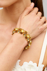 Profile view of model wearing the Oroton Flora Bracelet in Worn Gold and Vintage Austrian Crystal, Brown Moonstone Semi-Precious stone paste for Women .