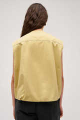 Profile view of model wearing the Oroton Cotton Twill Vest in Wheat and  for Women .