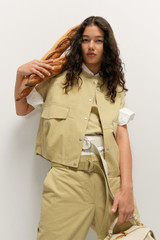 Profile view of model wearing the Oroton Quinn Webbing Belt in Wheat and 100% cotton material for Women .