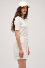 Profile view of model wearing the Oroton Alfie Carpenter Short in Antique White and Crafted from cotton twill  for Women .