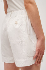 Profile view of model wearing the Oroton Alfie Carpenter Short in Antique White and Crafted from cotton twill  for Women .