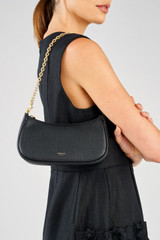 Profile view of model wearing the Oroton Eve Mini Baguette in Black and Pebble leather material for Women .