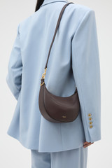 Profile view of model wearing the Oroton Florence Small Shoulder Bag in Mahogany and Premium smooth leather for Women .