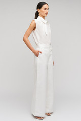 Profile view of model wearing the Oroton Wide Curved Leg Pant in White and 100% cotton material for Women