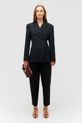 Profile view of model wearing the Oroton Wrap Blazer in Black and 98% wool,  2% elastane material for Women . IP:2