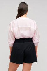 Profile view of model wearing the Oroton Belted Pleat Short in Black and 98% wool 2% elastane material for Women .