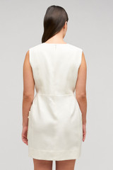 Profile view of model wearing the Oroton Rosebud Lace Mini Dress in Soft Cream and 100% linen material for Women