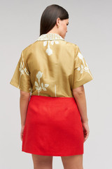 Profile view of model wearing the Oroton Embellished Rosebud Camp Shirt in Camel and 100% Silk Material for Women .