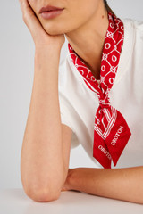 Profile view of model wearing the Oroton Eve Foulard Skinny Scarf in Dark Ruby/Cream and 100% polyester fabric for Women .