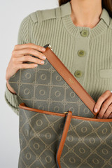 Profile view of model wearing the Oroton Harvey Signature Medium Zip Pouch in Black/Cognac and Nylon canvas base cloth material with PVC coating (70% PVC, 30% polyester) for Women .