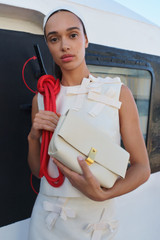 Profile view of model wearing the Oroton Etta Medium Clutch in Antique Cream and Premium smooth leather for Women . IP:8