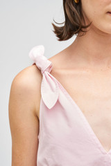Profile view of model wearing the Oroton Tie Shoulder A-Line Dress in Palest Pink and 100% cotton fabric for Women